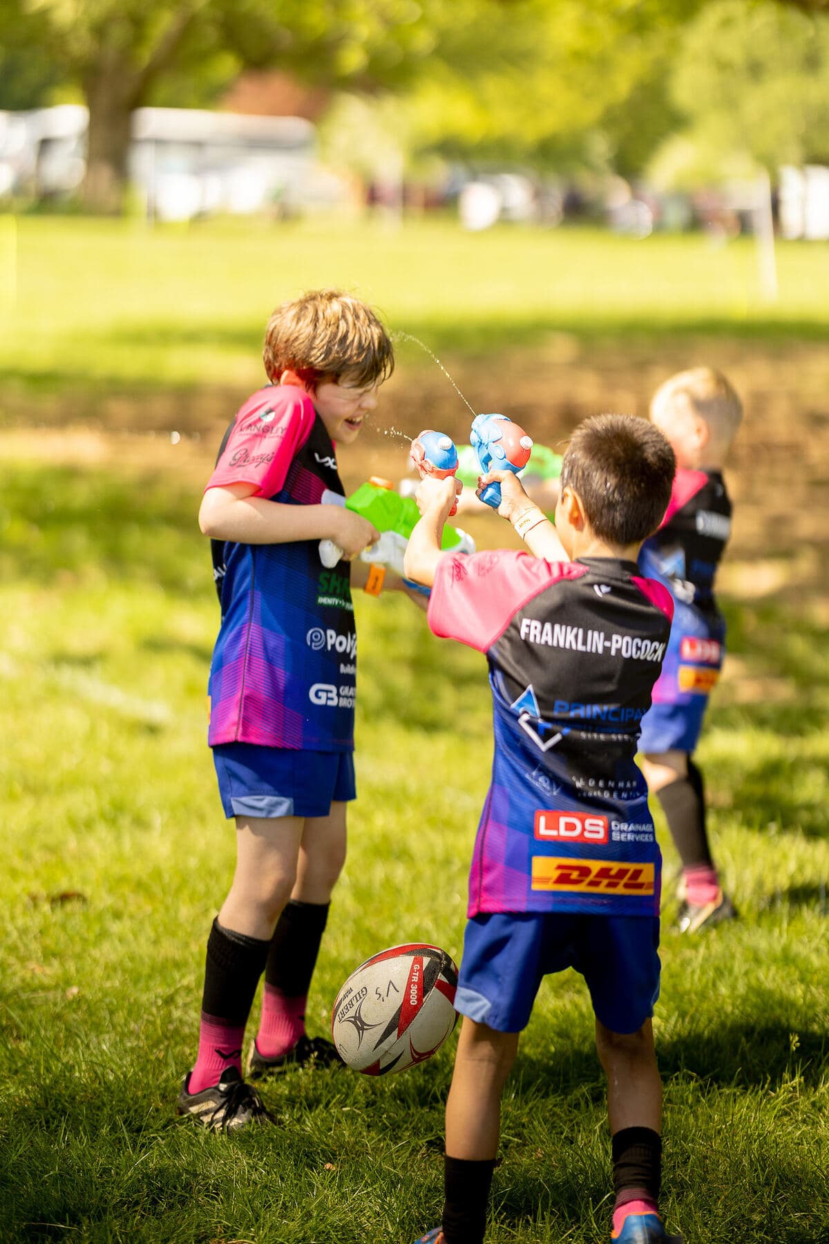 Improvised water-pistol battle on the pitch