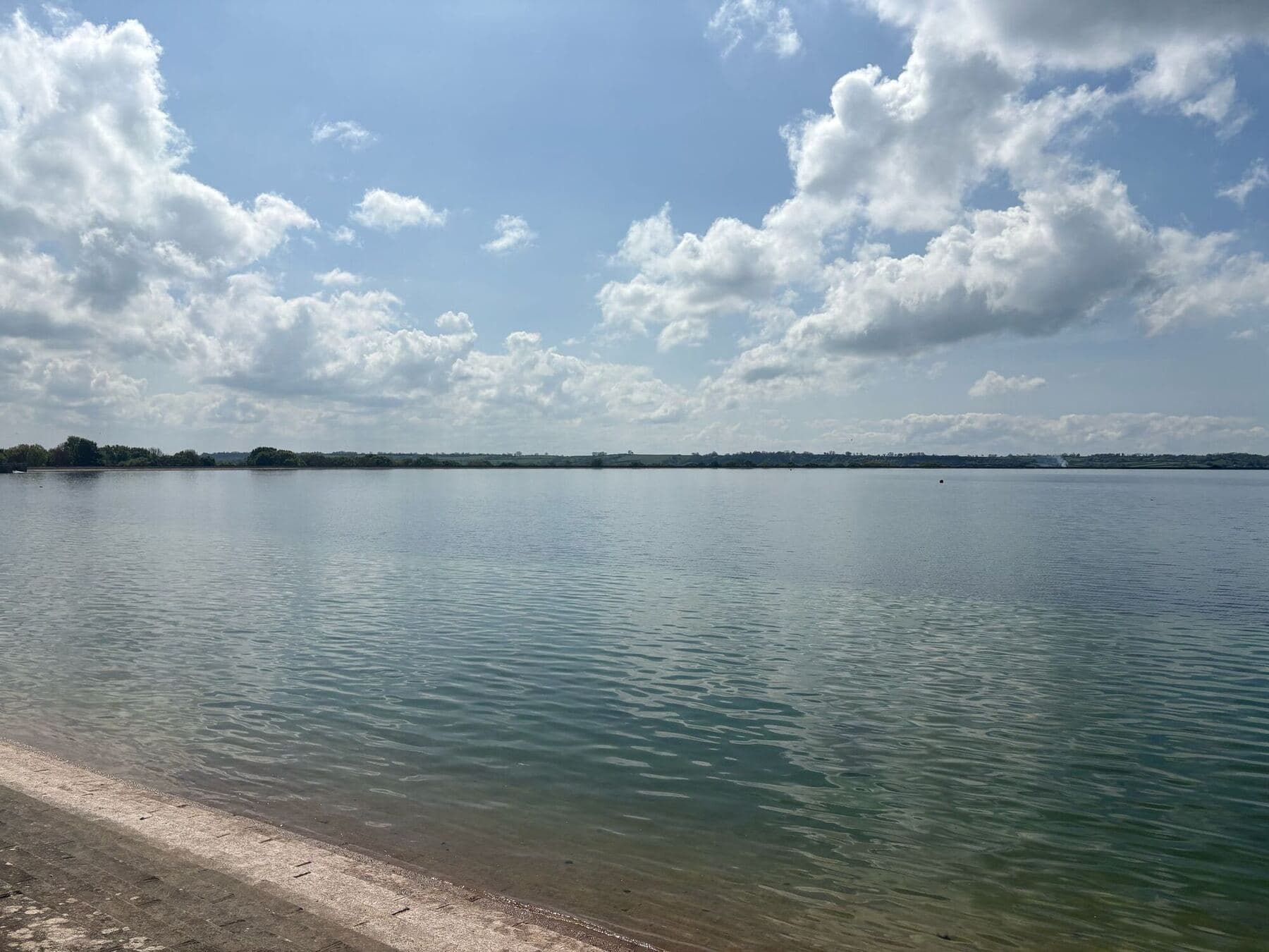 A wide stretch of calm water and open sky beside the touring party's base